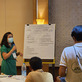 A woman is presenting in front of a group