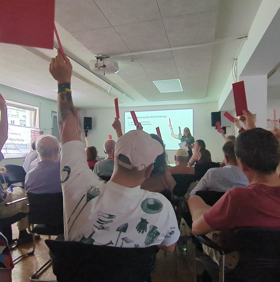 People raising their hands during a presentation